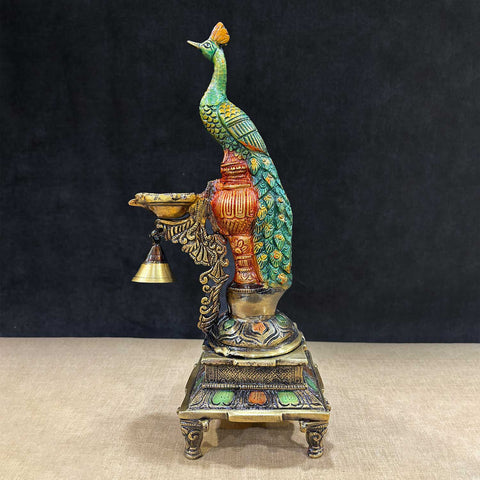 Colorful Brass Peacock Diya Stand with intricate detailing, showcasing a vibrant peacock perched gracefully above multiple diya holders, ideal for festive dΓ©cor and traditional worship settings. Indiaβs Largest Pooja Accessories Brand β www.satvikstore.in
