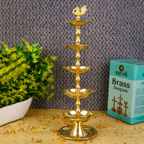 Brass 5 Step Peacock Kerala Diya β Handcrafted brass diya with a five-step structure and peacock design, perfect for pooja rituals, temple lighting, and traditional dΓ©cor. Indiaβs Largest Pooja Accessories Brand β www.satvikstore.in