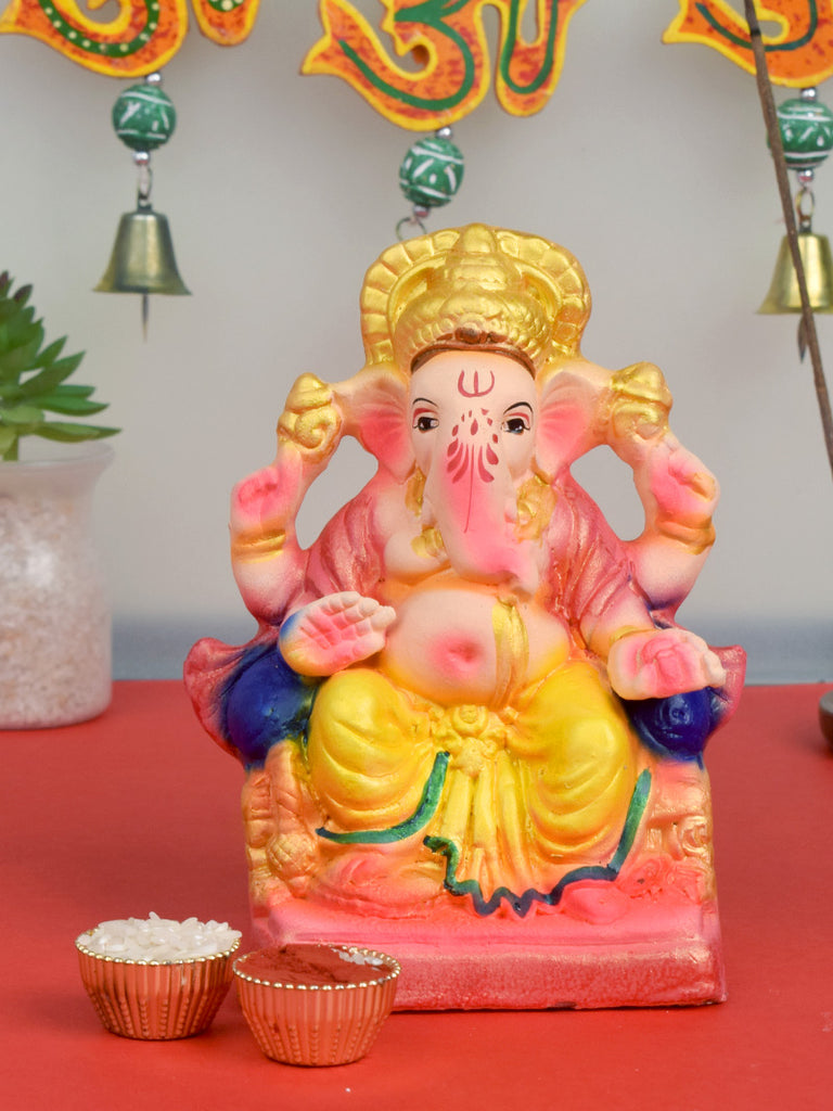 6-inch colorful eco-friendly Ganesha idol sitting on a decorative shinghasan, handcrafted from natural clay and painted with vibrant, non-toxic colors. India’s Largest Pooja Accessories Brand – www.satvikstore.in