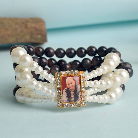 Black with White Pearl Four Layer Guruji Swaroop Bracelet featuring elegant black beads accented with luminous white pearls and Jai Guruji Swaroop – perfect for spiritual wear, festive gifting, and daily devotion. India’s Largest Pooja Accessories Brand – www.satvikstore.in