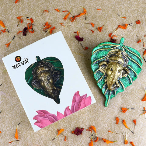 1 Pc Lord Ganesh Face on Leaf Patta Wall Hanging Green – Beautiful green leaf-shaped wall hanging with Lord Ganesha’s face embossed for spiritual and decorative home appeal. India’s Largest Pooja Accessories Brand – www.satvikstore.in